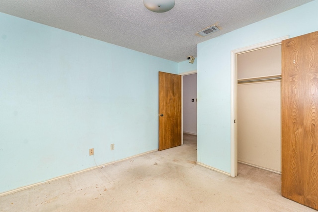 107 Russell Dr, Highland Village, TX 75077 - unfurnished bedroom featuring a closet, carpet floors, and a textured ceiling