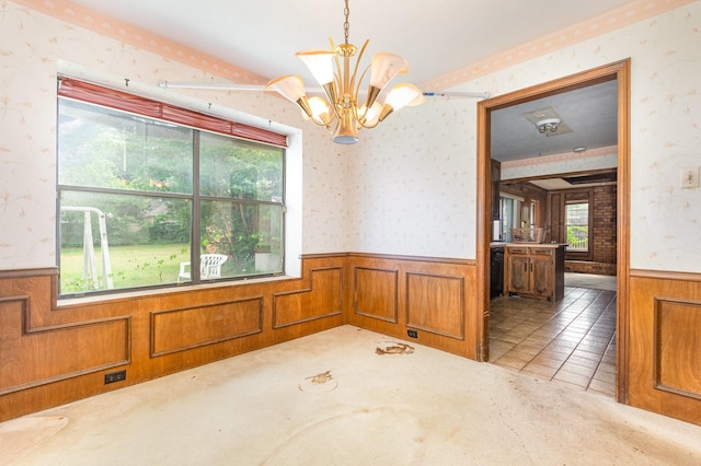 107 Russell Dr, Highland Village, TX 75077 - empty room with a wainscoted wall, wallpapered walls, a chandelier, wooden walls, and carpet floors