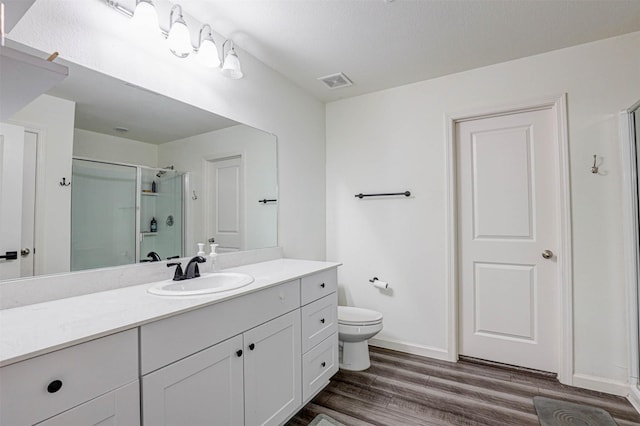 1600 Shadow Hawk Dr, Fort Worth, TX 76052 - bathroom featuring a shower stall, wood finished floors, toilet, vanity, and baseboards