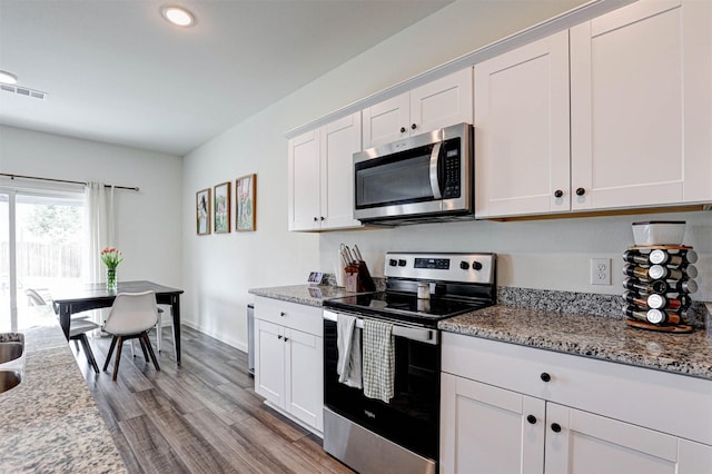 1600 Shadow Hawk Dr, Fort Worth, TX 76052 - kitchen featuring stainless steel appliances, white cabinets, light stone countertops, light wood finished floors, and recessed lighting
