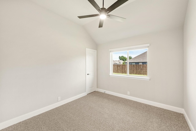 unfurnished room with light carpet, a ceiling fan, baseboards, and vaulted ceiling
