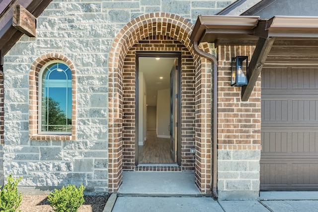 doorway to property featuring brick siding