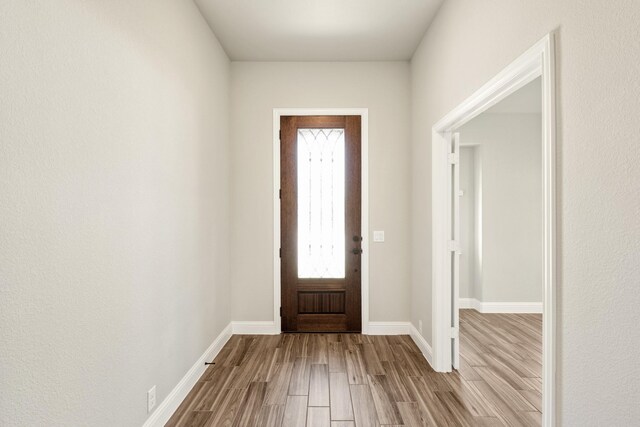 entryway featuring wood finished floors and baseboards