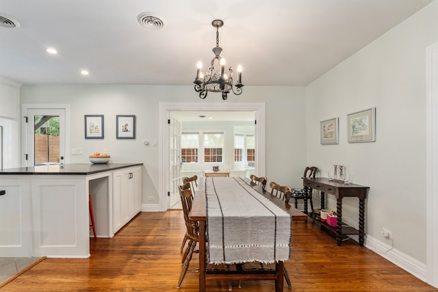 5107 Milam St, Dallas, TX 75206 - dining area with a notable chandelier, visible vents, and dark wood-type flooring