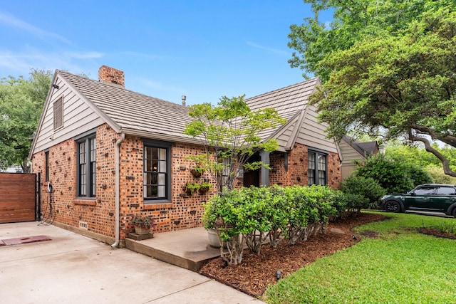 5107 Milam St, Dallas, TX 75206 - single story home with a chimney, brick siding, a front lawn, and crawl space