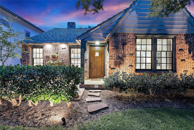 5107 Milam St, Dallas, TX 75206 - view of exterior entry with a chimney and brick siding