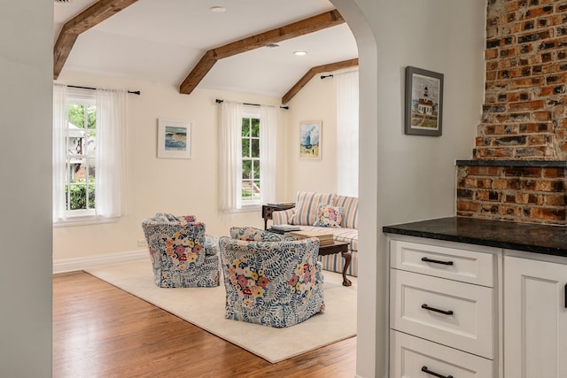 5107 Milam St, Dallas, TX 75206 - living area featuring a healthy amount of sunlight, arched walkways, vaulted ceiling with beams, and wood finished floors