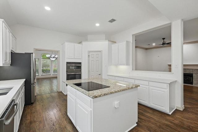 411 Deer Brooke Dr, Allen, TX 75002 - kitchen with stainless steel appliances, a center island, ceiling fan, dark wood-style flooring, and white cabinets