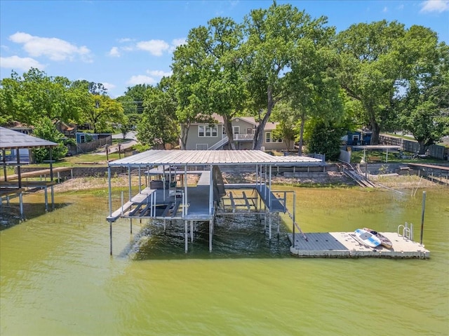 dock area featuring boat lift and a water view