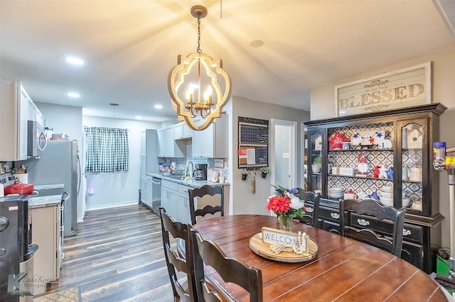 1773 Westview Dr, Abilene, TX 79603 - dining room with a chandelier, dark wood-style flooring, baseboards, and recessed lighting