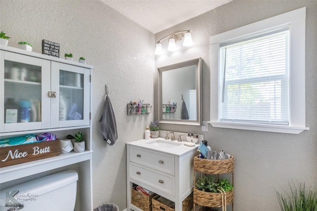 1773 Westview Dr, Abilene, TX 79603 - bathroom with a textured wall, vanity, and toilet