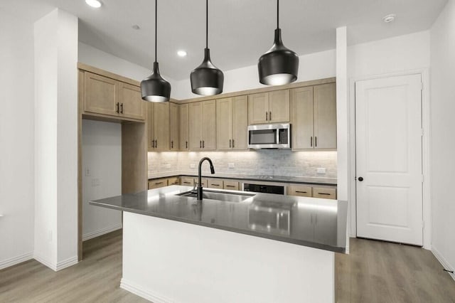 2418 Bulin, Mansfield, TX 76063 - kitchen with dark countertops, stainless steel microwave, light wood-style flooring, and a sink