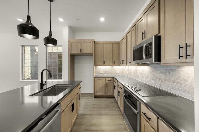 2418 Bulin, Mansfield, TX 76063 - kitchen with a sink, stainless steel appliances, light wood-style flooring, decorative backsplash, and dark countertops