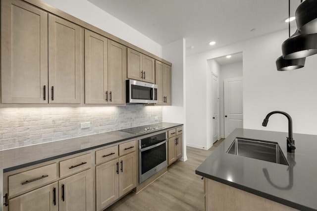 2418 Bulin, Mansfield, TX 76063 - kitchen with dark countertops, appliances with stainless steel finishes, a sink, and light wood-style floors