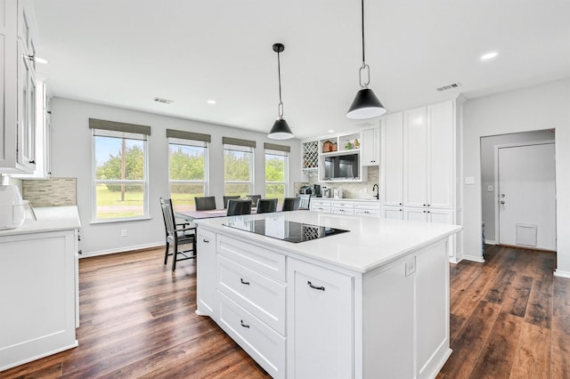 kitchen featuring white cabinetry, visible vents, tasteful backsplash, and black electric stovetop