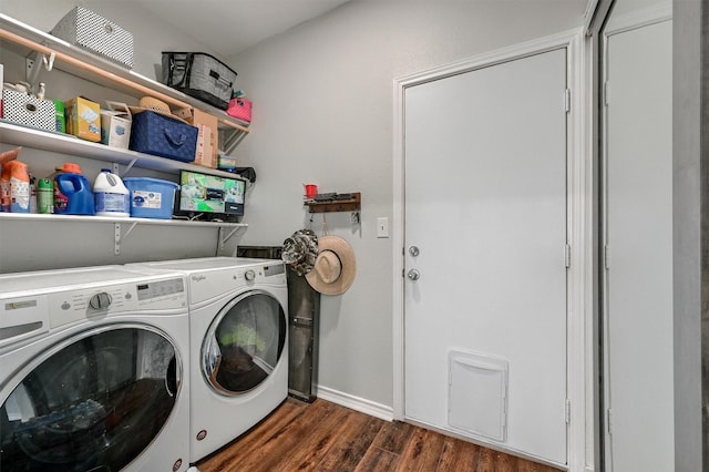 clothes washing area with laundry area, dark wood finished floors, baseboards, and washer and dryer