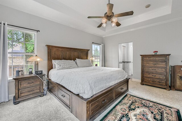 bedroom featuring baseboards, ornamental molding, ceiling fan, a raised ceiling, and light carpet