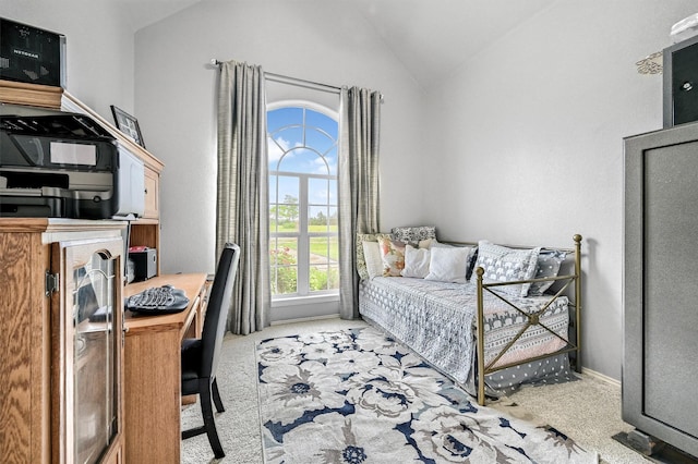 bedroom featuring vaulted ceiling, light colored carpet, and baseboards