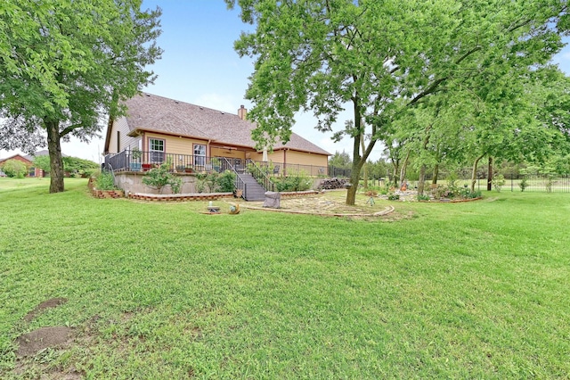 view of yard with fence and a deck