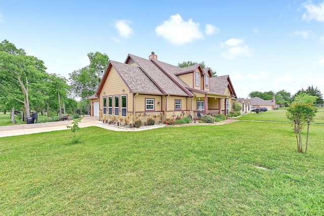 rear view of property with stone siding, driveway, a chimney, and a lawn