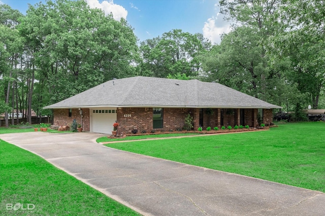 ranch-style home with concrete driveway, an attached garage, brick siding, and a front yard