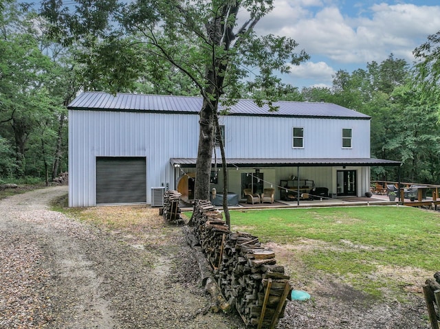 13533 Fm-1567 W, Brashear, TX 75433 - rear view of house with metal roof, dirt driveway, and a detached garage