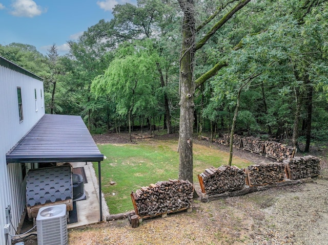 13533 Fm-1567 W, Brashear, TX 75433 - view of grassy yard featuring central AC and a forest view