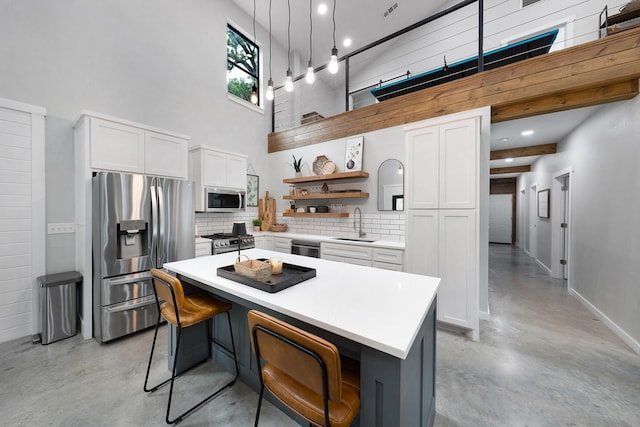 13533 Fm-1567 W, Brashear, TX 75433 - kitchen with stainless steel appliances, open shelves, finished concrete floors, backsplash, and white cabinetry