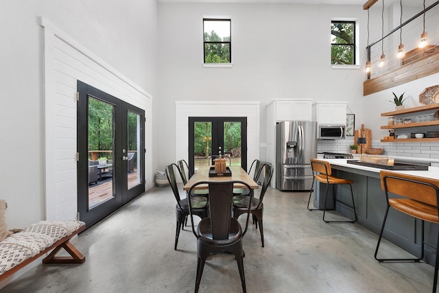 13533 Fm-1567 W, Brashear, TX 75433 - dining space featuring french doors, a high ceiling, and finished concrete flooring