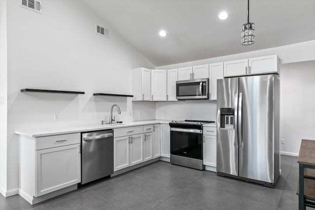 kitchen featuring light countertops, stainless steel appliances, visible vents, and a sink
