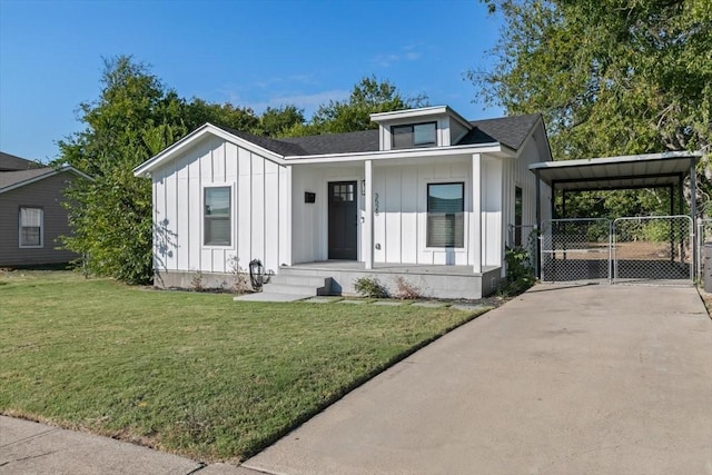 view of front of home with board and batten siding, covered porch, driveway, and a front yard