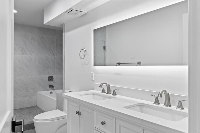 full bath with a sink, double vanity, toilet, and walk in shower