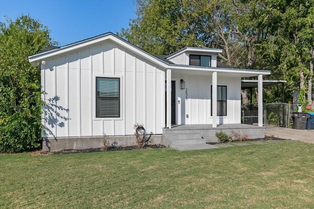 view of front of house featuring a porch, a front yard, and board and batten siding