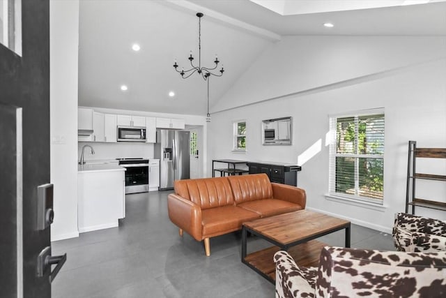 living area with beam ceiling, a wealth of natural light, a notable chandelier, and recessed lighting