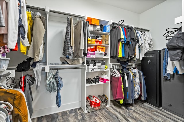 walk in closet with wood finished floors
