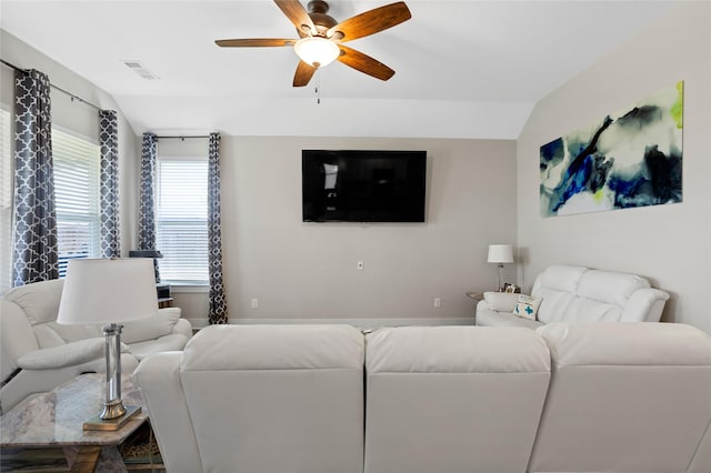 living room featuring ceiling fan, lofted ceiling, and visible vents