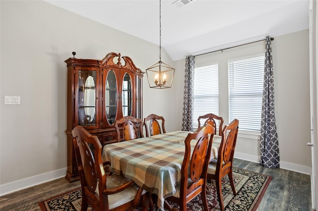 dining room featuring baseboards, dark wood-type flooring, an inviting chandelier, and vaulted ceiling