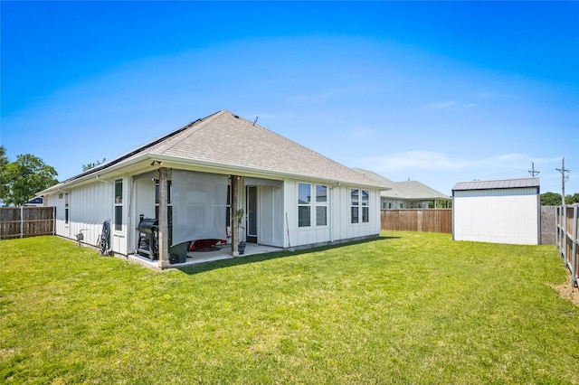 back of house featuring a patio, a shingled roof, board and batten siding, a fenced backyard, and a yard