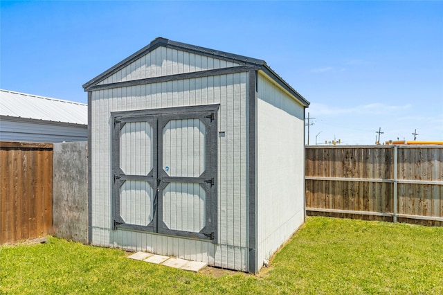 view of shed with a fenced backyard