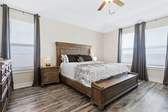 bedroom with ceiling fan, baseboards, visible vents, and dark wood finished floors