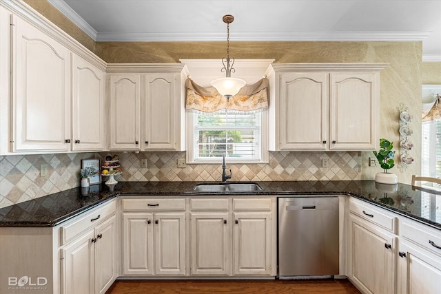 kitchen featuring backsplash, pendant lighting, a sink, and dishwasher