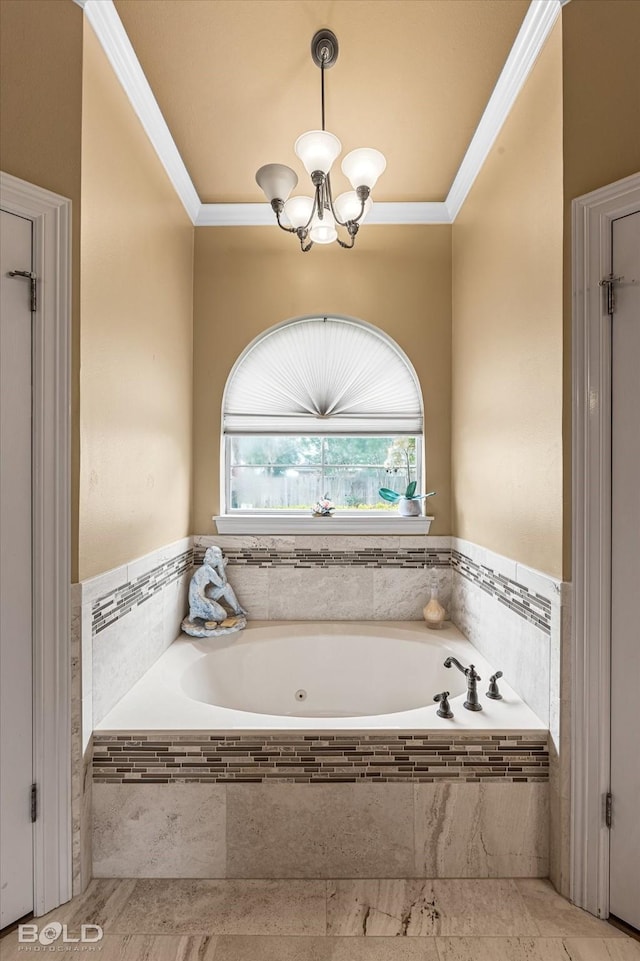 full bathroom featuring a garden tub, crown molding, and a notable chandelier