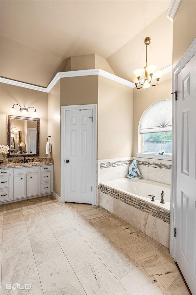 full bathroom with lofted ceiling, a notable chandelier, ornamental molding, a garden tub, and vanity