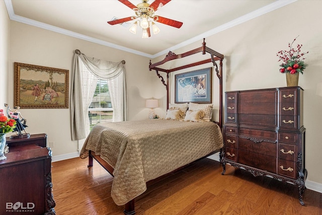 bedroom with a ceiling fan, wood finished floors, baseboards, and ornamental molding