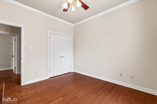 unfurnished bedroom with a ceiling fan, a closet, baseboards, ornamental molding, and wood finished floors