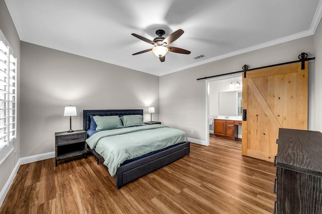 6224 Madrone Ct, Plano, TX 75074 - bedroom with a barn door, baseboards, wood finished floors, crown molding, and a sink