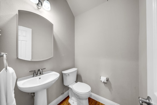 6224 Madrone Ct, Plano, TX 75074 - bathroom with toilet, wood finished floors, a sink, baseboards, and lofted ceiling