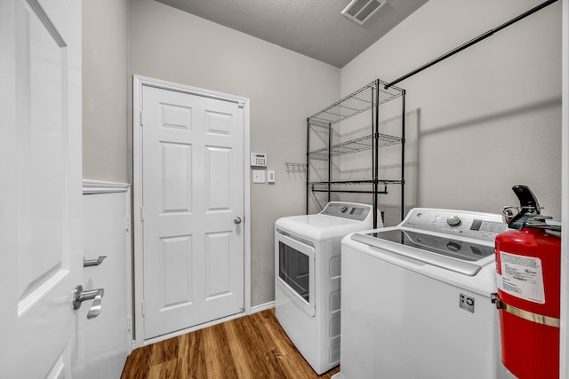 6224 Madrone Ct, Plano, TX 75074 - laundry area with independent washer and dryer and wood finished floors