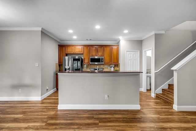 6224 Madrone Ct, Plano, TX 75074 - kitchen with appliances with stainless steel finishes, ornamental molding, wood finished floors, brown cabinets, and baseboards