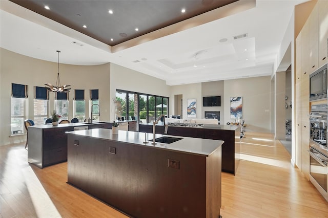 25 White Rock Trl, Lucas, TX 75002 - kitchen featuring a sink, a spacious island, visible vents, open floor plan, and a raised ceiling